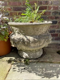 A set of four reconstituted stone circular bulbous garden urns